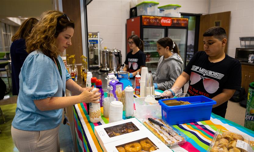 Students serve teachers from the school cafe